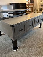 Overall view showing lift-top section raised, drawer fronts and metal legs