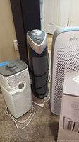 Three air purifiers grouped together for size and model reference, showing general condition and design