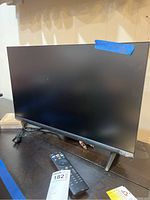 Full view of Vizio 24-inch TV showing screen and one leg support missing.