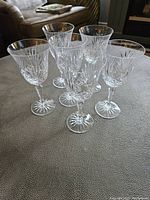 Six Miller Rogaska Richmond red wine glasses arranged on table, showing full set and design