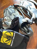 Photo of Body Glove snorkeling gear including flippers, snorkel, mask, and carrying bag on wooden surface