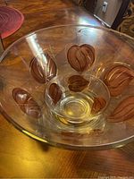 Large chip bowl showing the brown leaf pattern and gold accents with some wear visible
