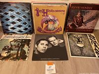 Six vinyl albums: Tommy; Are You Experienced?; Talking Book; Buffalo Springfield Again; Bookends; lion face cover