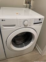 Front angled view of the LG washing machine showing overall condition