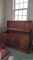 Front view of solid cedar chest with hinged lid open showing interior and lower drawer closed.