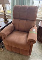 Front view of brown La-Z-Boy recliner chair showing plush cushioned back and seat with padded armrests.