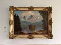 Full view of the framed landscape mountain nature painting hung on the wall showing overall condition and frame details.