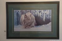 Framed Robert Bateman print showing a lynx in winter snow scene with green matting and dark frame.