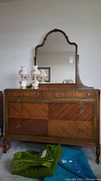 Front view of dresser with mirror attached, showing overall condition and styling