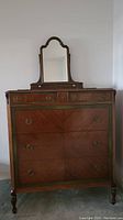 Full front view of highboy dresser with attached mirror
