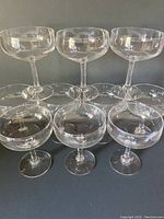 Six clear vintage crystal champagne stemmed bowls displayed in two rows, showing their shape and size