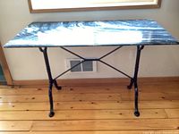 Full front view of assembled table showing marble top and cast iron base