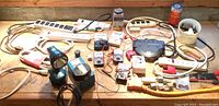 Overhead view of table showing power strips, battery testers, adapters, connectors and rotating power cube