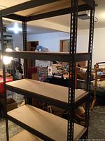 Front view of one shelving unit, metal frame with four particle board shelves