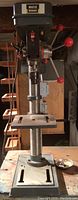 Front view of drill press showing base, column, table and head