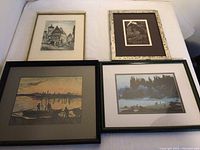 Four framed prints laid out: includes Van Gogh print 'Unloading Coal at Eventide', a black and white signed print by Elton Bennett, a black and white block print signed by Rothenburg, and a coastal beach scene print.