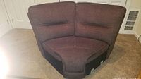 Brown fabric upholstered sectional wedge corner sofa piece showing overall structure and upholstery.