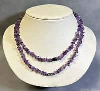 Front view of amethyst lariat necklace displayed on bust showing double strand and silver beads details.