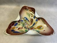 Top front angled view of the Murano glass bowl showing the colorful internal millefiori pattern and the clear thick glass edges.