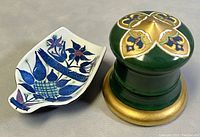 Top and side views of the hand-painted green and gold porcelain inkwell with the spoon rest featuring blue floral motifs.