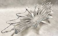 Angled three-quarter view of clear freeform crystal bowl showing spiky irregular rim