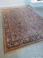 Full view of rug laid flat on floor showing overall pattern and color scheme
