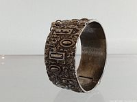 Front view showing textured surface and geometric motifs