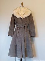 Full front view of long grey suede coat with fox fur collar and button closure, displayed on dress form.