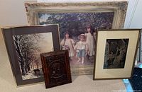 All four items including three framed prints with two girls and boy, winter skating scene, domestic scene, and carved wood plaque