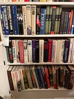 Bookshelves with history, politics, WWII, and Canadian subjects books arranged horizontally and vertically