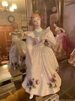 Front view of the Royal Doulton porcelain figurine showing detailed features and floral decoration on the dress