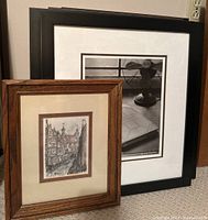 Two framed art pieces side by side on floor, showing overall presentation and size difference.