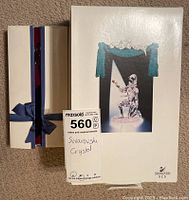 Boxed Swarovski Masquerade Harlequin kneeling figure shown on box outer with brand logo