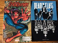 Cover of 'The Amazing Spider-Man Beyond Volume One' and 'Deadly Class' graphic novels side by side, showing front covers in color.