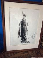 Framed black and white photo of a flapper woman, signed 'Best wishes Lil', in wood frame with white matting.