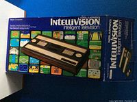 Original box showing Mattel Intellivision Intelligent Television branding and image of console with 18 game screenshots on box sides.