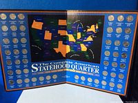 Front view of the open quarter collection folder showing most of the quarters and the U.S. map layout.