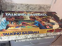 Original box with colorful image of a boy and man playing the Talking Baseball game, featuring branding and game information.