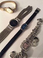 Photo showing all four watches on a flat surface, highlighting different styles and bands.