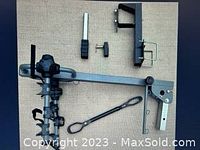 Photo showing the full bike rack and its mounting hardware parts on a fabric surface.