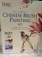 Front cover of 'The Complete Chinese Brush Painting Set' book showing bird and flower artwork with title and author Jane Dwight.