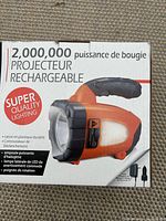 Box front showing orange rechargeable flashlight specification including 2,000,000 candlepower, LED side lighting, and rotating handle.