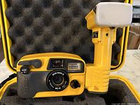 Yellow and black Sea & Sea MX-10 Motor Marine 35 camera with lens and built-in flash showing camera front.