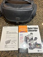 Original carrying case, Sony Digital8 Video Camera recorder manual, and an instructional book for digital camcorders titled 'How to Do Everything with Your Digital Video Camcorder'.
