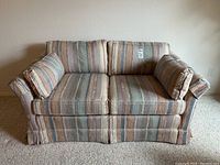Front view of the Drexel Heritage love seat showing the striped fabric, two seat cushions, and two matching bolster pillows.