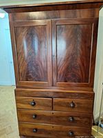 Full view of antique solid wood hutch showing wood grain, two large doors on top, and four drawers below