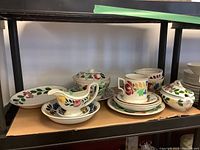 Full lot of Welsh ceramics and Sponge ware including gravy boat, covered serving dishes and plates with floral hand-painted designs.