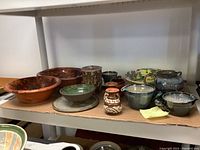 Overview of entire shelf with assorted ceramic items