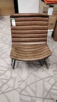 Front view of the brown vinyl ribbed cushioned chair with chrome cantilever frame.
