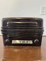 Front view of the Sparton radio showing dial, tuning knobs, and brand name.